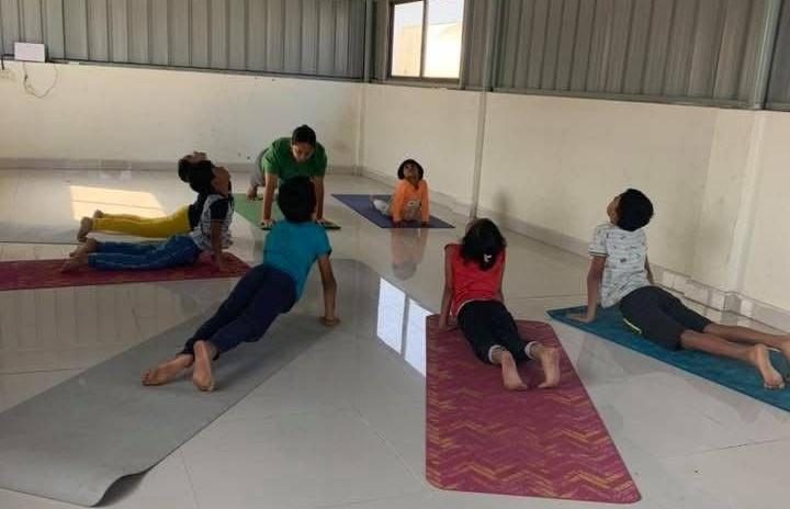 Children practising floor asanas on yoga mats